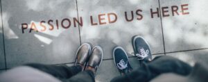 two-people-standing-on-grey-tile-pavement