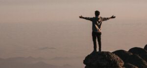 man-standing-beside-cliff