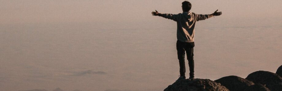 man-standing-beside-cliff