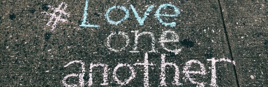 love-one-another-chalk-written-on-concrete